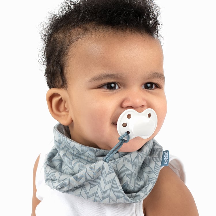 A baby sucking on a pacifier 