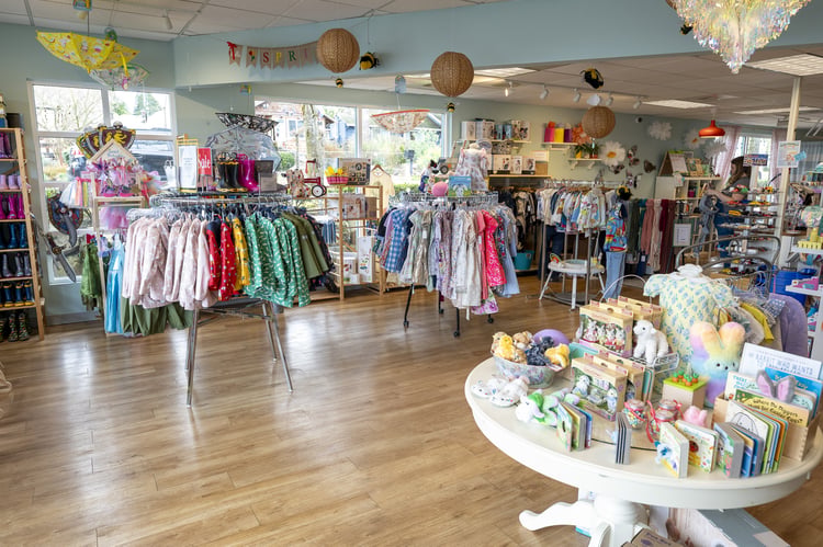 Colorful store with children’s clothing, books, and toys 