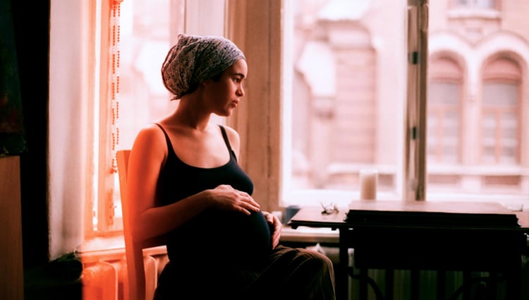 Woman looking thoughtfully out a window