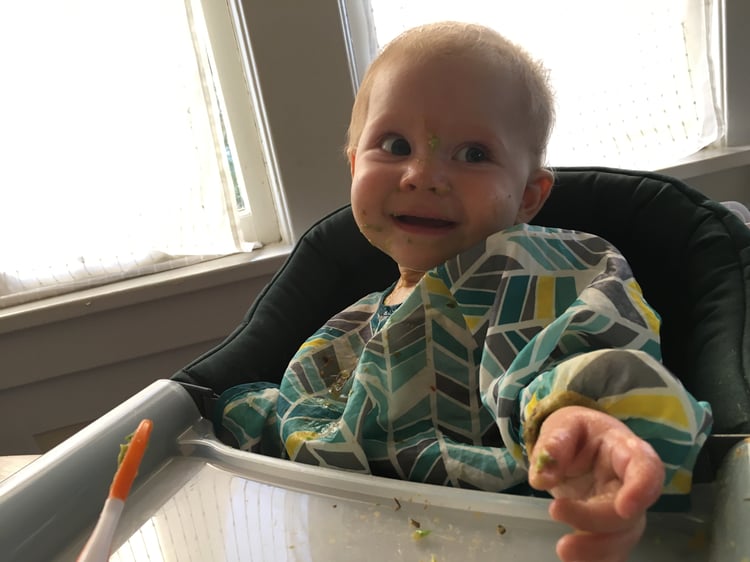 child eating avocado