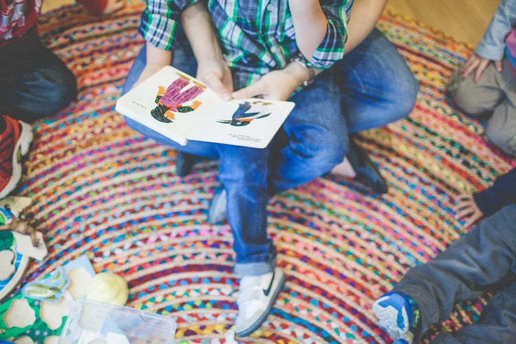 Child having a book read to them