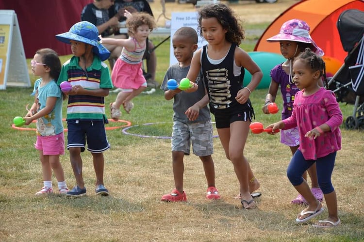 Kids competing in an egg and spoon race