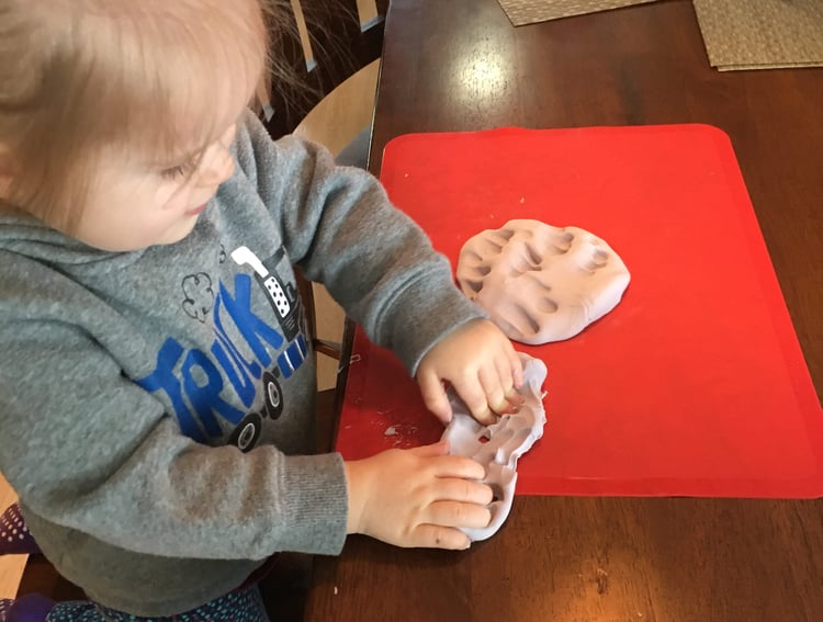 child playing with modelling clay