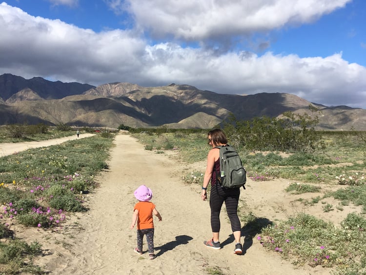 Megan and child walking along sandy trail