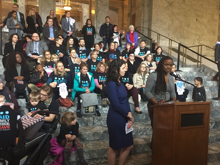 Parents and allies advocating for Paid Family and Medical Leave in Washington State, on the steps of a building in Olympia