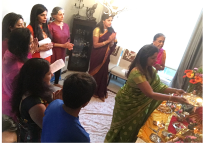 Swarnima and group of women standing in front of the idols
